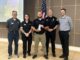 Oskaloosa Police Officer Logan Nord, center, holds the 2026 Iowa Association of School Resource Officers School Resource Officer of the Year award. Oskaloosa Police Chief Ben Boeke and Oskaloosa City Manager Shawn Metcalf are pictured to Nord’s left during the award presentation. Photo submitted.