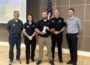 Oskaloosa Police Officer Logan Nord, center, holds the 2026 Iowa Association of School Resource Officers School Resource Officer of the Year award. Oskaloosa Police Chief Ben Boeke and Oskaloosa City Manager Shawn Metcalf are pictured to Nord’s left during the award presentation. Photo submitted.