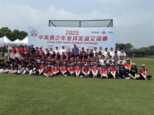 Youth softball players from Iowa and China gather for a group photo during the 2025 China-USA Youth Softball Exchange in Shanghai, China. The 2025 event marked the beginning of the Musco Youth Sports Exchange program. Photo courtesy of Musco.