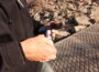 A volunteer uses nitrate test strips to test nitrate concentrations in the Des Moines River. (Photo by Cami Koons/Iowa Capital Dispatch)