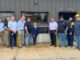 U.S. Rep. Mariannette Miller-Meeks, center, and Clow Valve Vice President and General Manager Mark Willett, standing to the right of the plaque, join Clow Valve team members outside the company’s Metal Casting Facility during Miller-Meeks’ Aug. 6, 2026, visit to Oskaloosa.