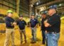 Democratic gubernatorial candidate Rob Sand, from left, with Scott Wheeler, Lincolnway Energy; Jeff Taylor, Lincolnway Energy; Chris Cleveland, Lincolnway Energy and Bill Couser, Story County farmer, tours the Lincolnway Energy ethanol plant in Nevada, Iowa, on Aug. 18, 2026. (Photo by Joanna Schroeder for Iowa Capital Dispatch)