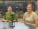 Lilia Morris and Carrie Bihn seated behind microphones during an Oskaloosa News interview about The Hub.