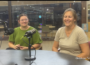 Lilia Morris and Carrie Bihn seated behind microphones during an Oskaloosa News interview about The Hub.