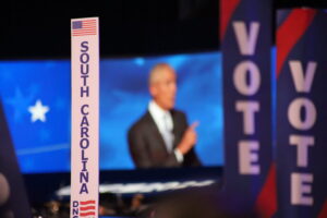  The South Carolina delegation’s sign is seen as former President Barack Obama speaks at the Democratic National Convention in Chicago in 2024. (Photo by Shaun Griswold / Source New Mexico)