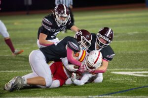 Three Oskaloosa defenders bring down a Marion ball carrier during the Indians’ home football game on Friday, October 16th, 2026, at Statesmen Community Stadium in Oskaloosa. The Indians battled back to within three points at halftime before Marion pulled away for a 41-10 victory.