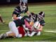Three Oskaloosa defenders bring down a Marion ball carrier during the Indians’ home football game on Friday, October 16th, 2026, at Statesmen Community Stadium in Oskaloosa. The Indians battled back to within three points at halftime before Marion pulled away for a 41-10 victory.