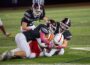 Three Oskaloosa defenders bring down a Marion ball carrier during the Indians’ home football game on Friday, October 16th, 2026, at Statesmen Community Stadium in Oskaloosa. The Indians battled back to within three points at halftime before Marion pulled away for a 41-10 victory.