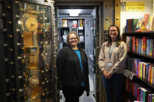 Angela Crist, Director of Wilcox Library, and Kelsey Jacobs, co-owner of Book Vault, celebrate the bookstore’s Parent/Family Weekend gift to William Penn University.